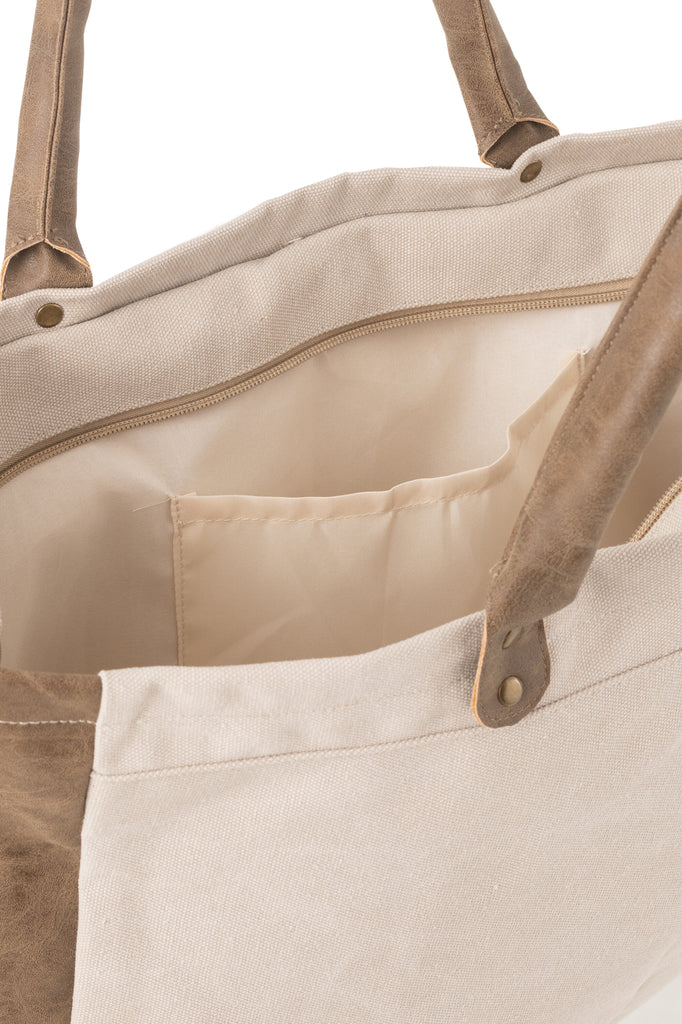 Strandtas met korte handvatten van textiel in het beige.